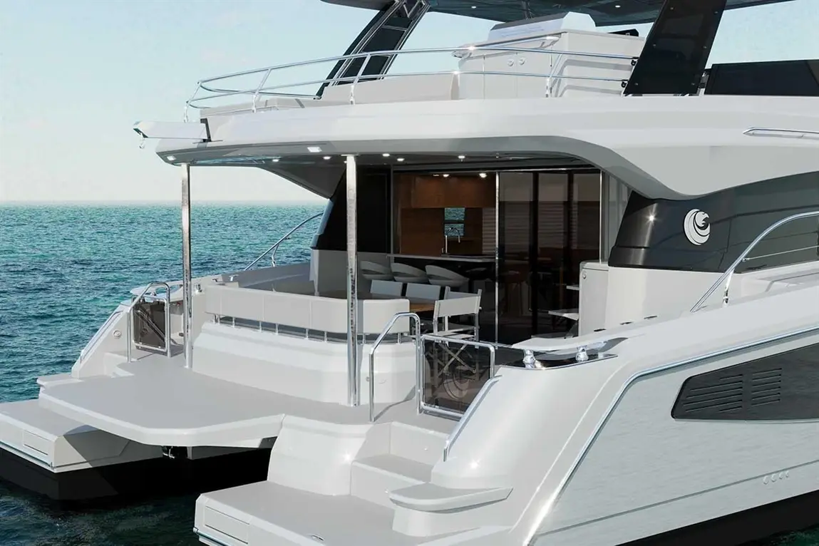 Luxury catamaran docked by the sea featuring a spacious deck, modern seating area, and panoramic windows in the cabin.